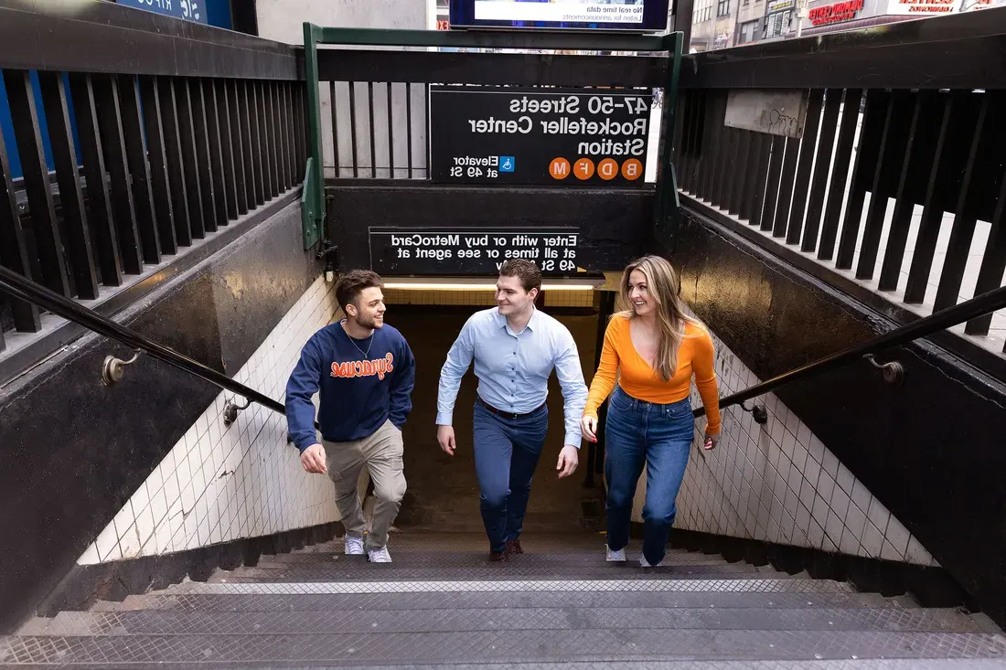 People walking up stairs at New York City subway station.
